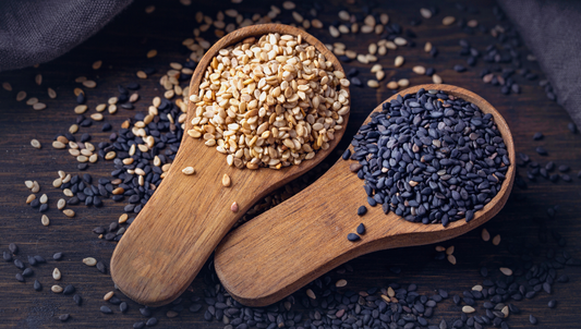 white and black sesame seeds in spoon