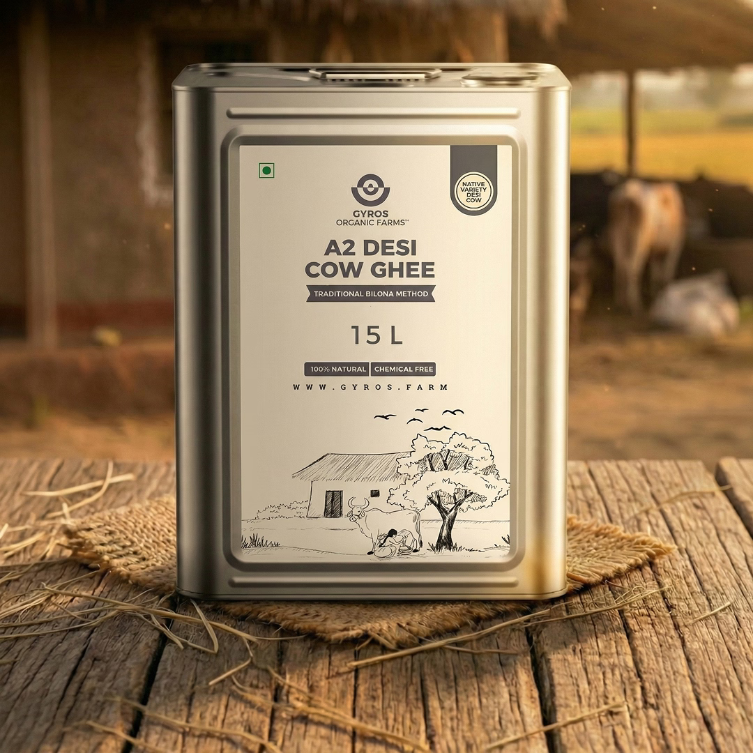 Gyros A2 desi cow ghee 15L tin container displayed on a wooden surface in a village environment.