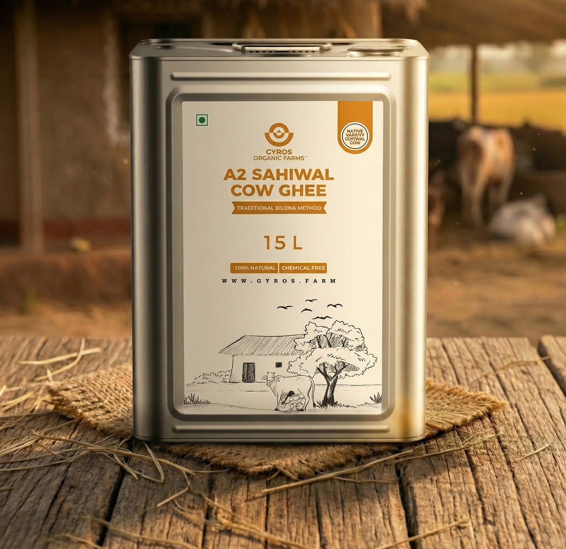 Gyros A2 Sahiwal cow ghee 15L metal tin container placed on a wooden surface in a rural setting.