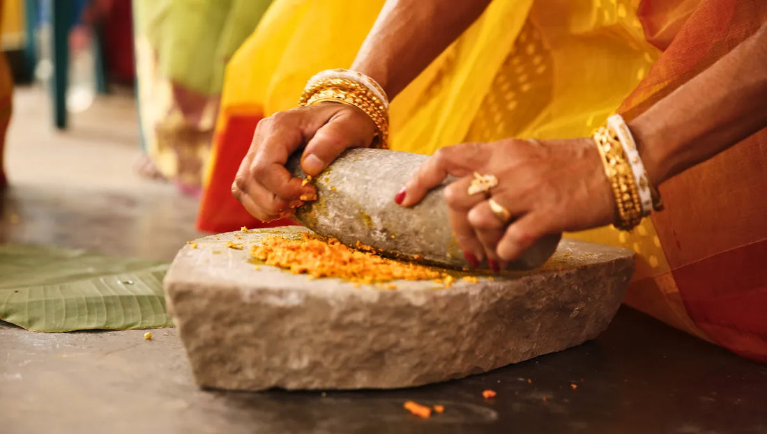 Indian Woman grinding Turmeric