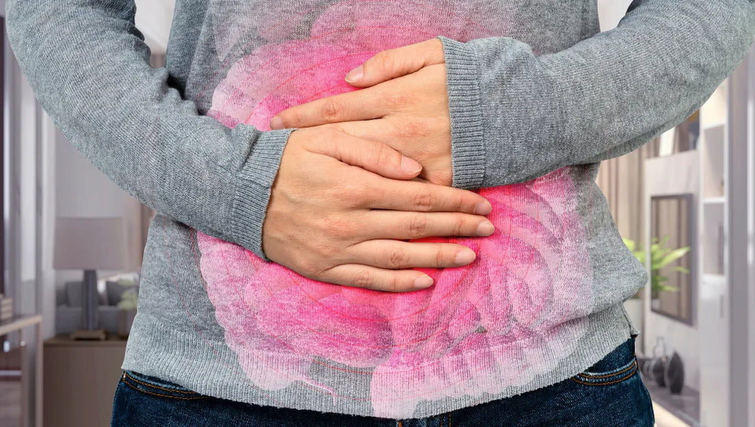 Person holding stomach with red highlight indicating digestive discomfort.