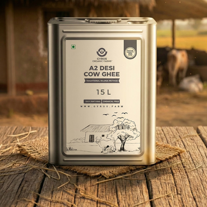 Gyros A2 desi cow ghee 15L tin container displayed on a wooden surface in a village environment.