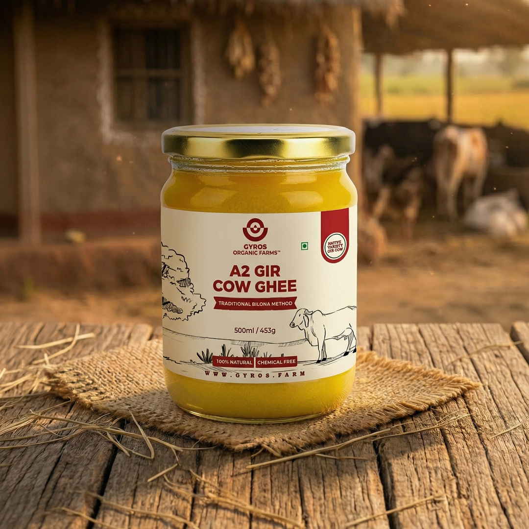 500ml A2 Gir cow ghee jar on wooden table with cows and village in background