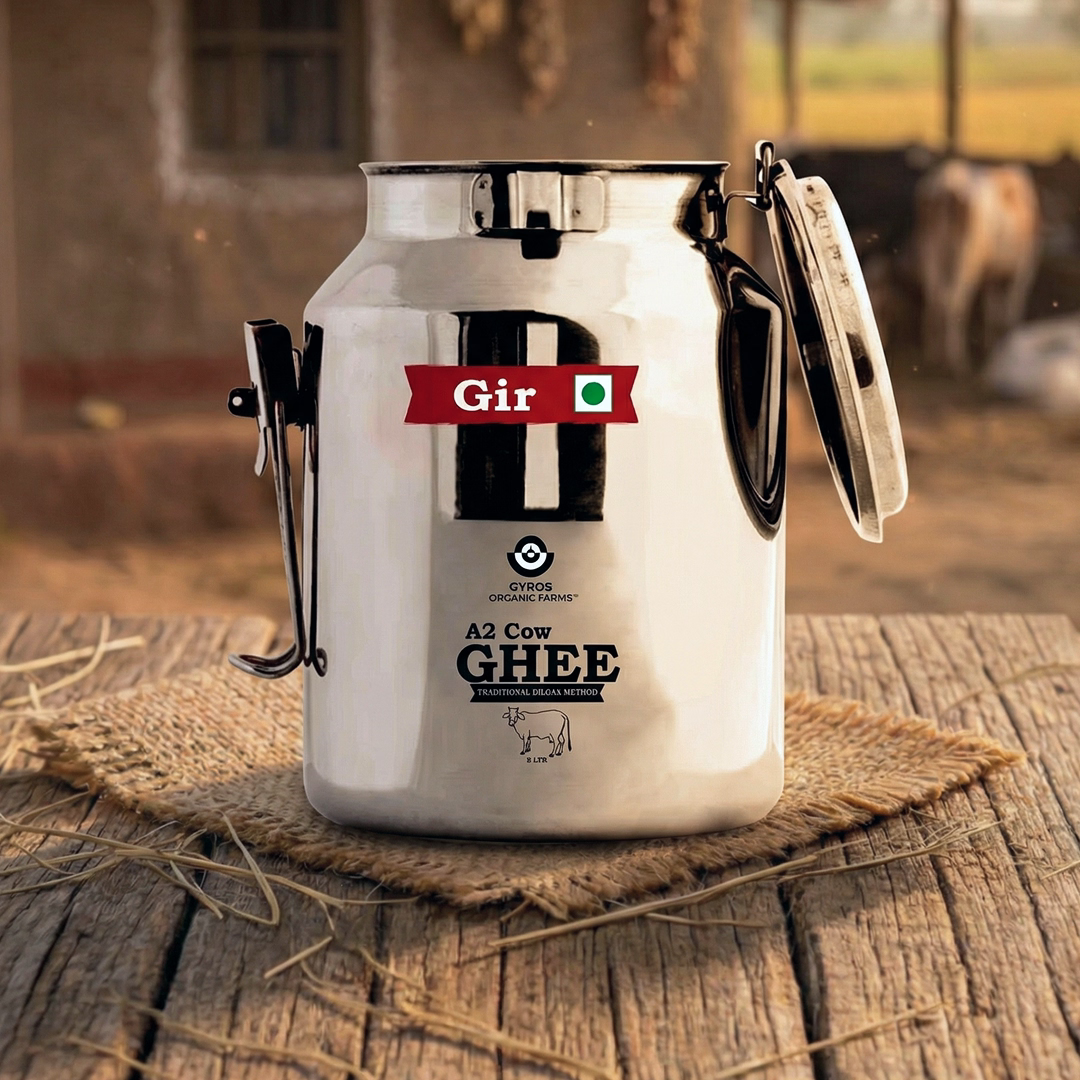 A2 cow ghee stored in a traditional stainless steel dolchi with open lid on wooden surface