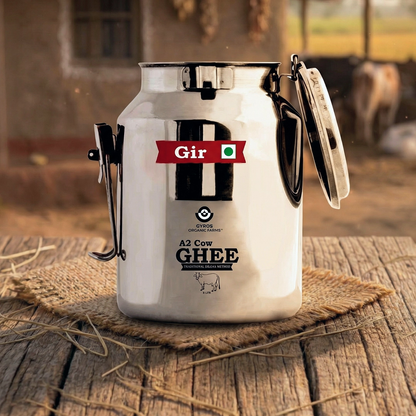 A2 cow ghee stored in a traditional stainless steel dolchi with open lid on wooden surface