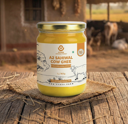 Gyros A2 Sahiwal cow ghee 1L glass jar placed on a wooden surface with warm rural lighting.