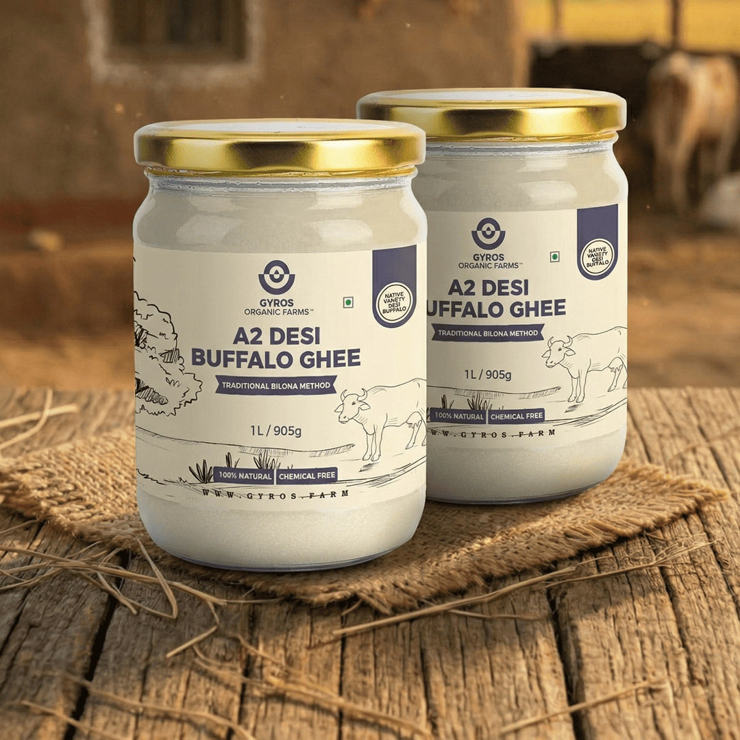 Pack of two Gyros A2 desi buffalo ghee jars placed side by side on a rustic wooden table.
