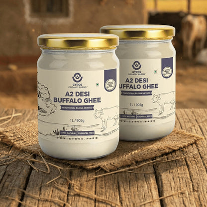 Pack of two Gyros A2 desi buffalo ghee jars placed side by side on a rustic wooden table.